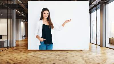 Beautiful smiling woman holding and presenting copy space on her palm isolated on white background Wall mural