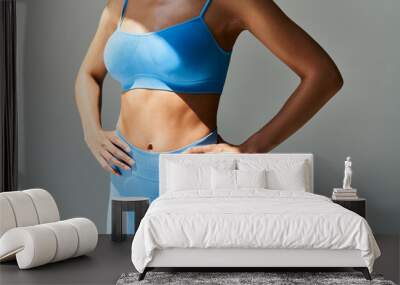 Cropped image of fit woman torso  on grey background Wall mural