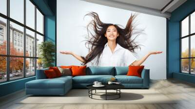 Happy young Asian woman with beautiful flying long hair Wall mural