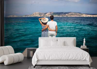 Young couple in love enjoy beautiful sea landscape on pier in Italy Wall mural