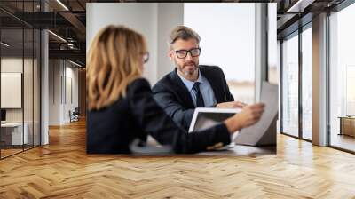 Shot of two businesspeople working on a laptop in the boardroom. Teamwork at the office. Wall mural