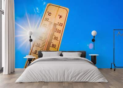 Summer background - blue sky with bright sun and thermometer Wall mural