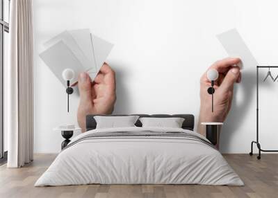 Two hands display blank cards in varying configurations, suggesting a brainstorming session or game preparation while set against a stark white backdrop Wall mural