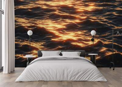 Golden light reflecting on the dark rippling water. Wall mural