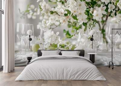 Spring table setting with blooming branches, green apples, and white dishes. Wall mural