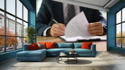 Businessman leafing through documents and signing contract for business deal at work in office closeup. Certification of documentation and control concept Wall mural