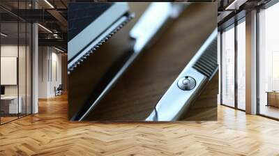 Close-up of two pairs of scissors for cutting and thinning out clients hair. Professional hairdresser equipment for work in salon. Metal tool laying on wooden table Wall mural