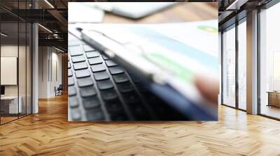 Group of people working with financial reports clipped to pad at workplace closeup Wall mural