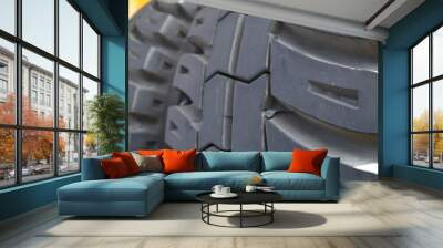 Huge rear wheels of dump truck at unusual angle closeup Wall mural