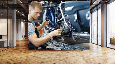 Master repairman repairing motorcycle in workshop with tools Wall mural