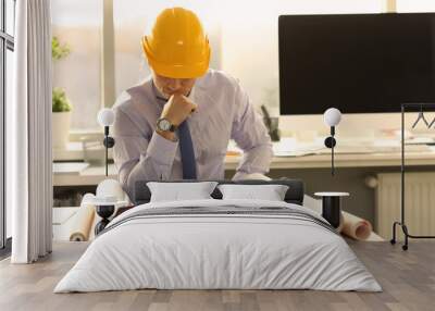 Pensive Architect Think at Engineering Office. Industrial Building Draft Design Concept. Busy Engineer Doubt at Workplace. Business Man Wearing Shirt and Yellow Hard Hat Upset Wall mural