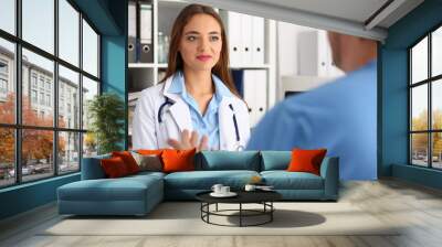 Professional young medical worker consulting her patient Wall mural