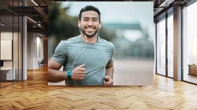 Fitness, portrait and man running with earphones for music, radio or sport podcast for motivation. Sports, exercise and male athlete runner doing outdoor cardio workout for race or marathon training. Wall mural