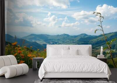 A scenic view of a lake nestled in a valley, surrounded by lush green mountains and wildflowers. Wall mural