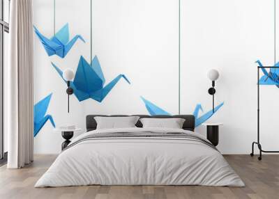 Blue origami paper cranes haning isolated white Wall mural