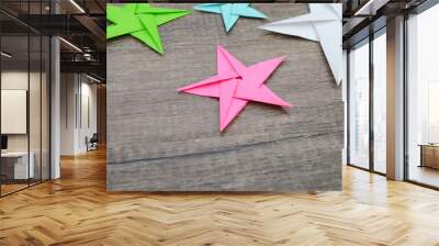 holiday paper stars on wooden background Wall mural