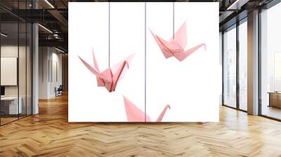 Pink origami crane papers hanging on white Wall mural