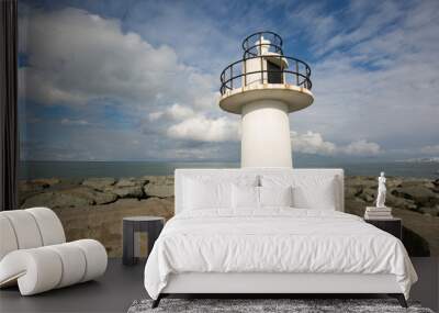 Lighthouse on the sea under sky. Wall mural