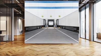 Loading dock of large warehouse with white truck under loading Wall mural