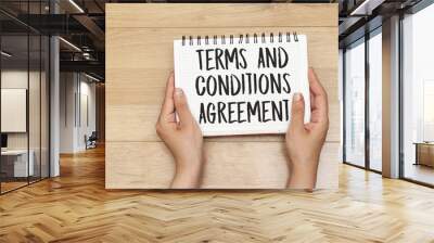 hands holding a notebook with terms and conditions agreement concept Wall mural