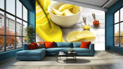 potato chips on white glass bowl with spoons of mustard and red pepper Wall mural