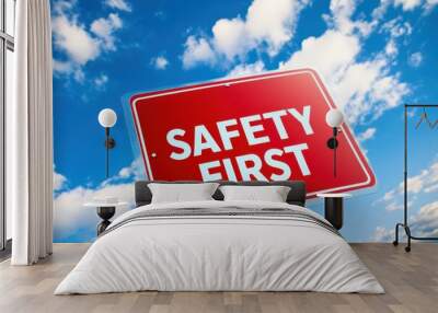 A bold 'SAFETY FIRST' sign set against a bright blue sky Wall mural