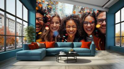 A happy diverse team of startup business people celebrate their business success amidst confetti Wall mural