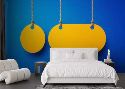 two yellow tags hanging from a rope on a blue background Wall mural