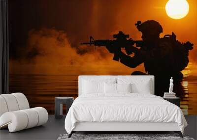 A man in a black uniform is in the water with a rifle Wall mural