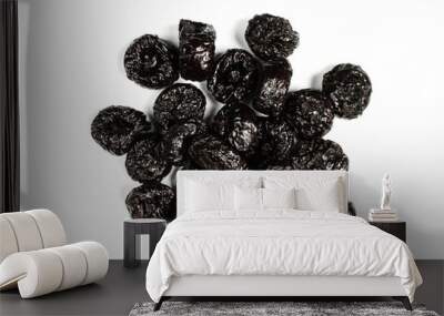 Pile of delicious prunes isolated on white background. Dried fruit Wall mural