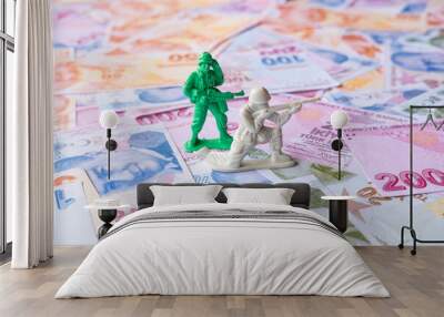 Two toy soldiers on Turkish Lira, spending money for war, mercenary concept, conceptual warfare idea, sitting view, different banknotes from Turkey with mercenary soldier Wall mural