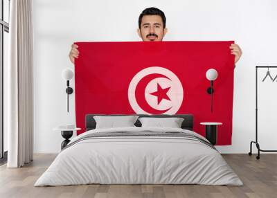 Young man holding Tunisia flag, celebration or campaigning concept, independence day idea, two  Wall mural