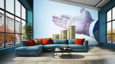 Coin stack growing with graph chart and businessman hand.business growth and financial concept Wall mural