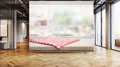 Fabric cloth or placemat on wood table top on blur kitchen room background.For montage product display Wall mural