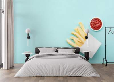 Top view of french fried with tomato sauce ( ketchup ) on blue pastel table background Wall mural