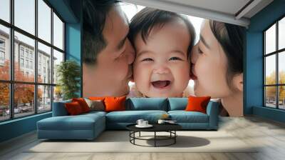 A family of three, a man, a woman and a baby, are hugging each other Wall mural