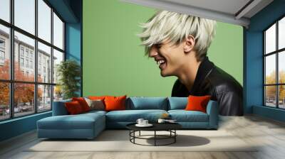 A woman with blonde hair and a black jacket is smiling Wall mural