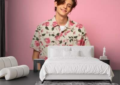 A young man is wearing a floral shirt and smiling Wall mural