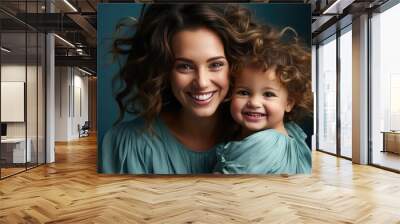 Beautiful portrait of a mother and her little child making faces, light blue background, studio photos. created by generative AI technology. Wall mural