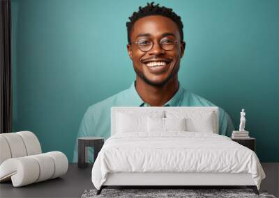 happy handsome fashion African American man smiling and wearing color cloth, solid light color background Wall mural