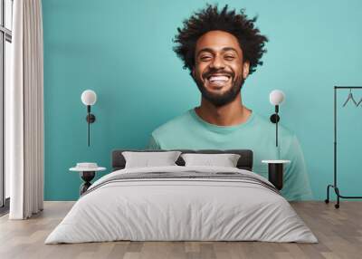 happy handsome fashion African American man smiling and wearing color cloth, solid light color background Wall mural