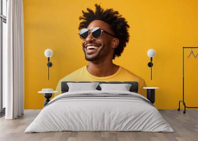 happy handsome fashion African American man smiling and wearing color cloth, solid light color background Wall mural