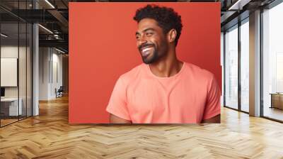 happy handsome fashion African American man smiling and wearing color cloth, solid light color background Wall mural