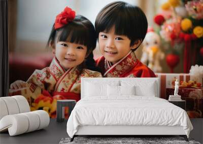 Happy kids wear red Chinese traditional clothing with gift boxes in Chinese lunar New Year Wall mural