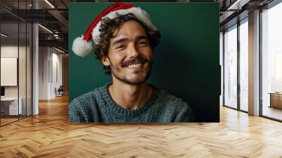 happy smiling handsome man with Santa hat in Christmas background Wall mural