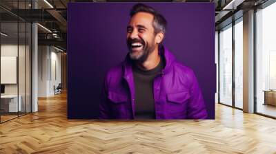 Happy ultra young handsome man, who is smiling and laughing, wearing bright clothes. Bright solid purple background. created by generative AI technology. Wall mural