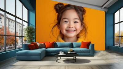 little Asian girl with colorful sweatshirt in professional colorful photo studio background Wall mural