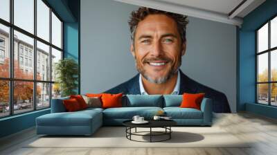 Portrait of handsome smiling businessman with suit in professional studio background Wall mural