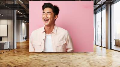 smiling handsome vogue Asian man on solid color background Wall mural