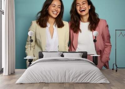 Two women are smiling and wearing suits Wall mural